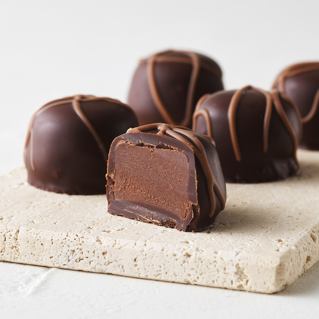 Stimmungsbild:  Butter-Trüffel Zartbitterschokolade mit Vollmilchschokoladen-Dekor dekorativ aufgeschnitten Stimmungsbild:  Butter-Trüffel Zartbitterschokolade mit Vollmilchschokoladen-Dekor dekorativ aufgeschnitten